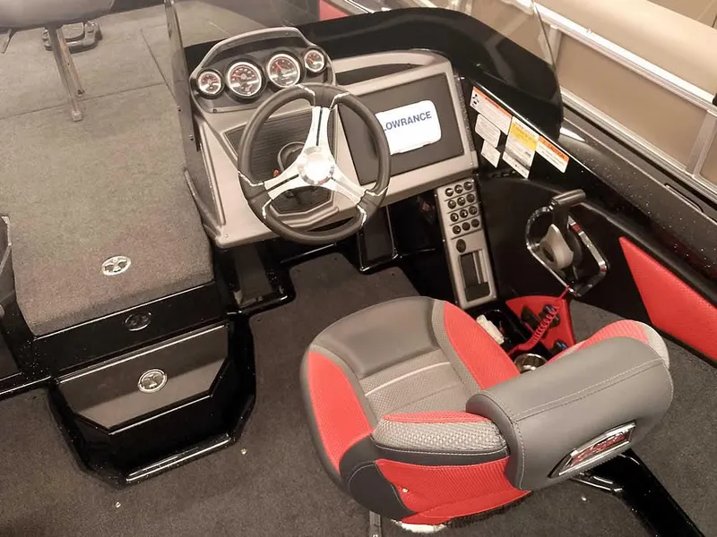 Slide: The Image of 2024 Ranger 2080MS Angler boat cockpit with steering wheel, gauges, and red-accented seat. - 26