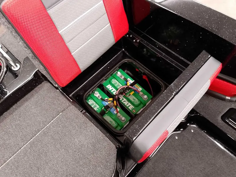 Slide: The Image of 2024 Ranger 2080MS Angler boat battery compartment with red and gray seating. - 31