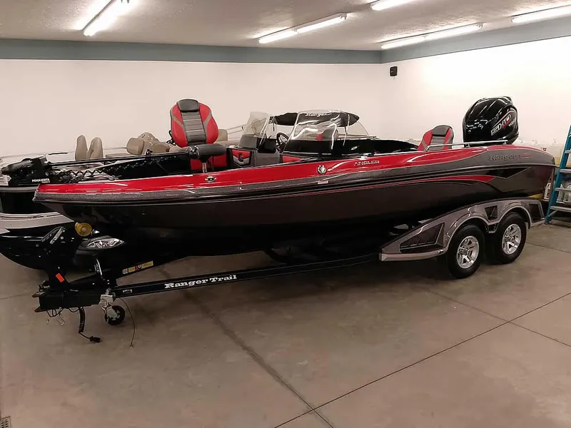 Slide: The Image of 2024 Ranger 2080MS Angler boat in showroom, red and black design, on trailer. - 35