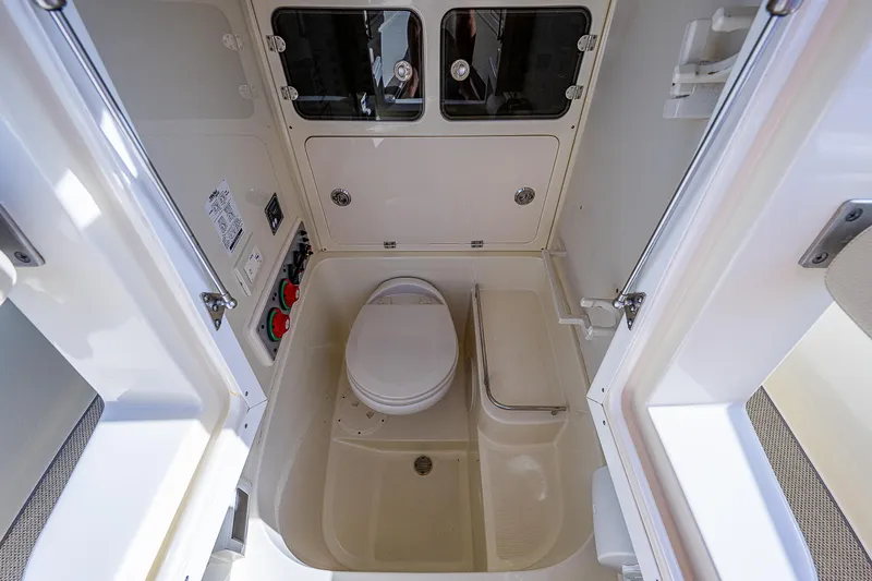 Slide: The Image of 2019 Chris-Craft Catalina 27 boat bathroom interior with toilet and storage compartments. - 18