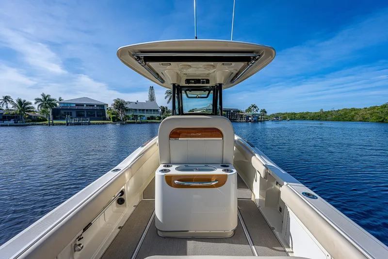Slide: The Image of 2019 Chris-Craft Catalina 27 boat on serene water, showcasing sleek design and spacious deck. - 24
