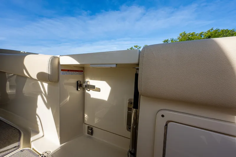 Slide: The Image of 2019 Chris-Craft Catalina 27 interior detail with beige upholstery and blue sky background. - 25