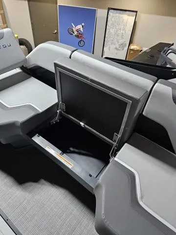 Slide: The Image of 2025 Manitou 20' Cruise Bench with open storage compartment, showcasing sleek design and functionality. - 13