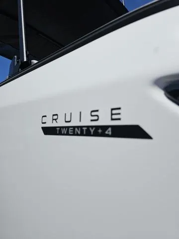 Slide: The Image of 2025 Manitou Cruise Bench boat with 150HP Stealth motor, close-up of logo. - 4