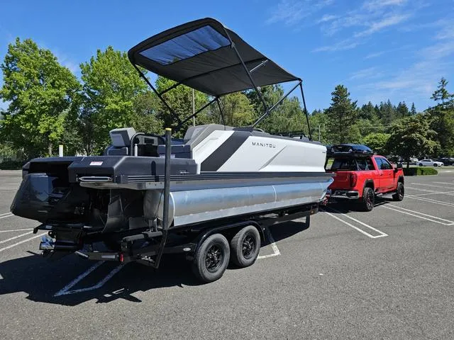Slide: The Image of 2025 Manitou 20' Cruise Bench Max Deck boat with 150HP Stealth motor on trailer. - 5