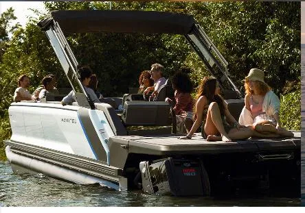 Slide: The Image of 2025 Manitou 22' Cruise Max Deck boat with 150HP Stealth motor on a scenic waterway. - 3