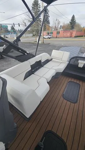 Slide: The Image of 2025 Manitou 24 EXPLORE DUAL MOTOR NAVIGATOR with sleek seating and wooden deck. - 10