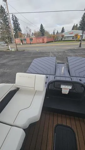 Slide: The Image of 2025 Manitou 24 EXPLORE DUAL MOTOR NAVIGATOR boat with sleek seating and modern design. - 14