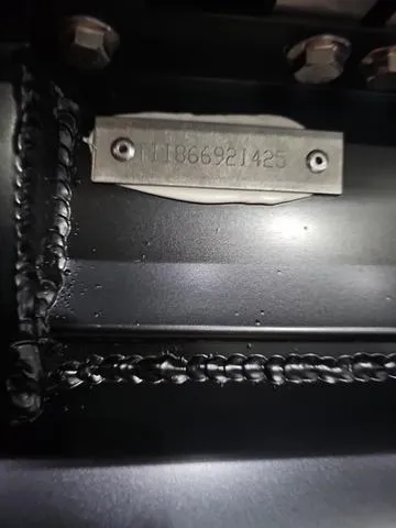 Slide: The Image of Close-up of a metal plate with serial number on a 2025 Manitou 24 Explore Dual Motor Navigator. - 29