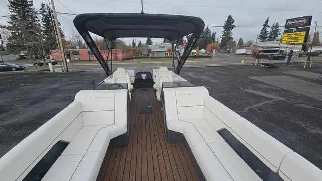 Slide: The Image of 2025 Manitou 24 EXPLORE DUAL MOTOR NAVIGATOR pontoon boat with spacious seating and canopy. - 4