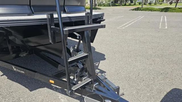 Slide: The Image of Trailer ladder of 2025 Manitou Explore 24 Max Deck Navigator in parking lot. - 14