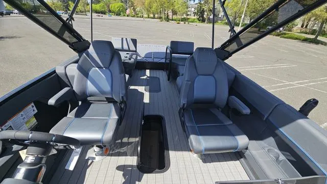 Slide: The Image of 2025 Manitou Explore 24 Max Deck Navigator interior with modern seating and steering wheel. - 15