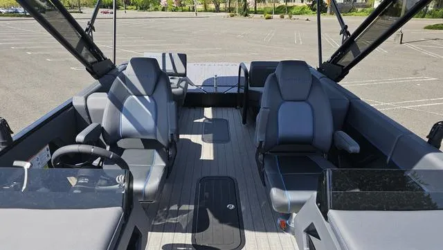 Slide: The Image of 2025 Manitou Explore 24 Max Deck Navigator interior with modern seating and spacious layout. - 17