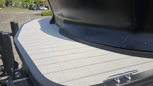 Slide: The Image of 2025 Manitou Explore 24 Max Deck Navigator, close-up of deck surface in a parking lot. - 4