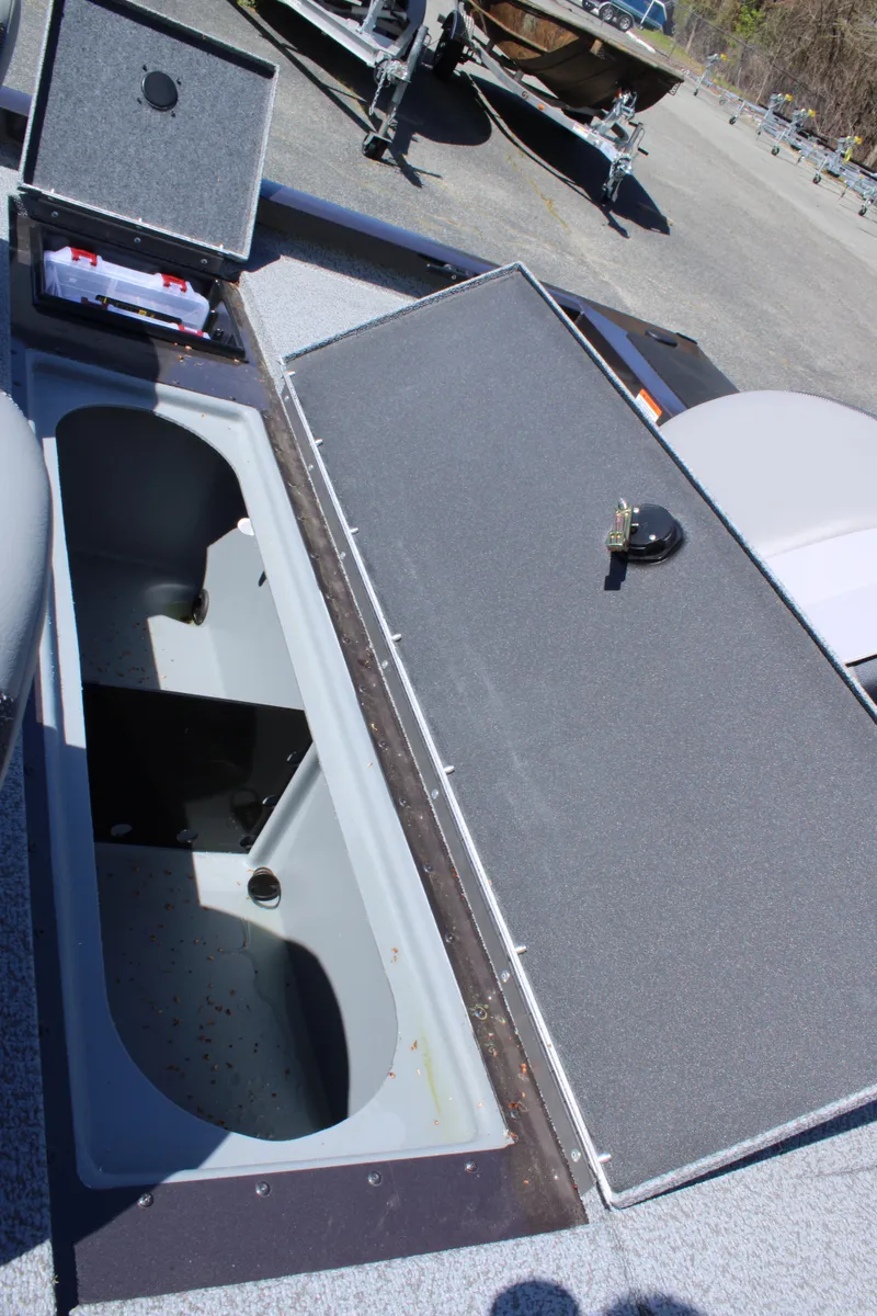 Slide: The Image of 2025 G3 Sportsman 1610 boat storage compartments open, showcasing interior space. - 18