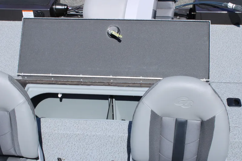 Slide: The Image of 2025 G3 Sportsman 1610 boat interior with open storage compartment and gray seating. - 19