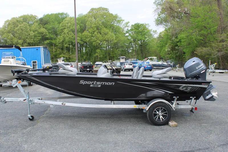 Slide: The Image of 2025 G3 Sportsman 1610 boat on trailer, parked outdoors. - 2