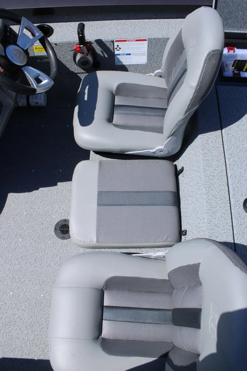 Slide: The Image of 2025 G3 Sportsman 1610 boat interior with gray seating and steering wheel. - 23