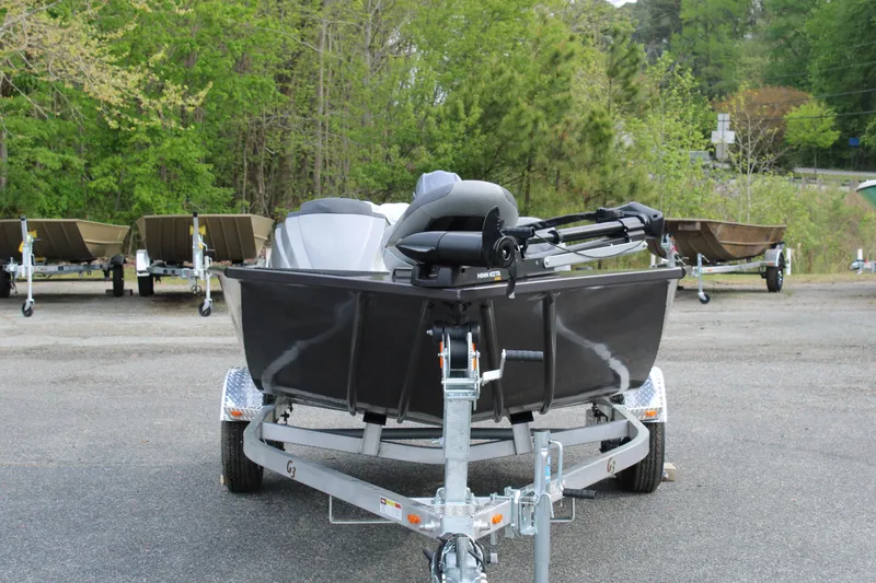 Slide: The Image of 2025 G3 Sportsman 1610 boat on trailer, parked outdoors with trees in background. - 8