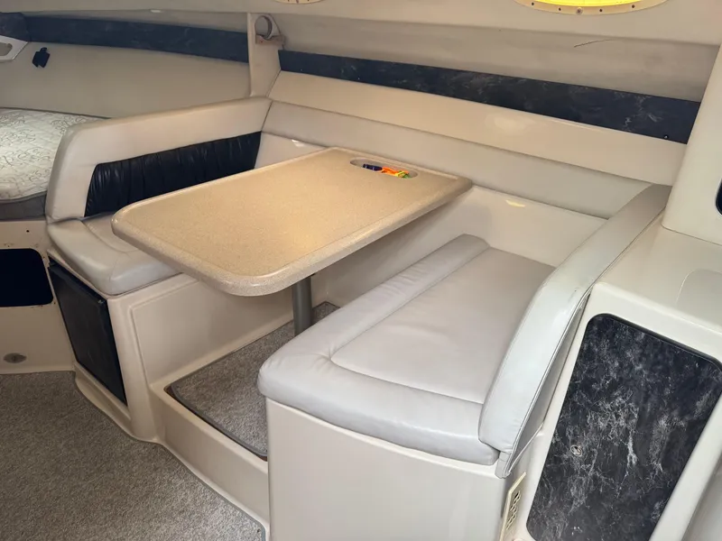 Slide: The Image of 1998 Wellcraft 3000 Martinique cabin interior with dining area and seating. - 10