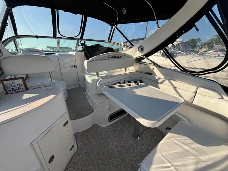 Slide: The Image of 1998 Wellcraft 3000 Martinique boat interior with seating and table, featuring a "River is my happy place" sign. - 22