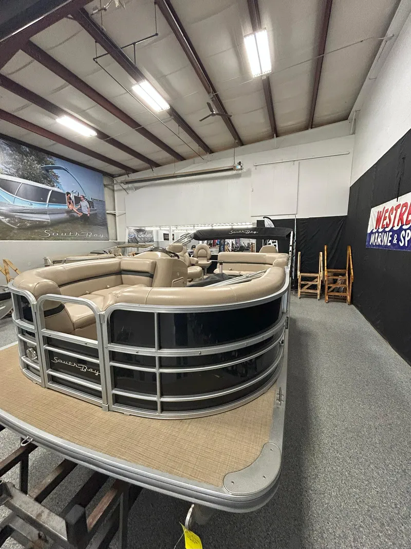 Slide: The Image of 2018 South Bay 220FCR pontoon boat displayed indoors at a marine showroom. - 3