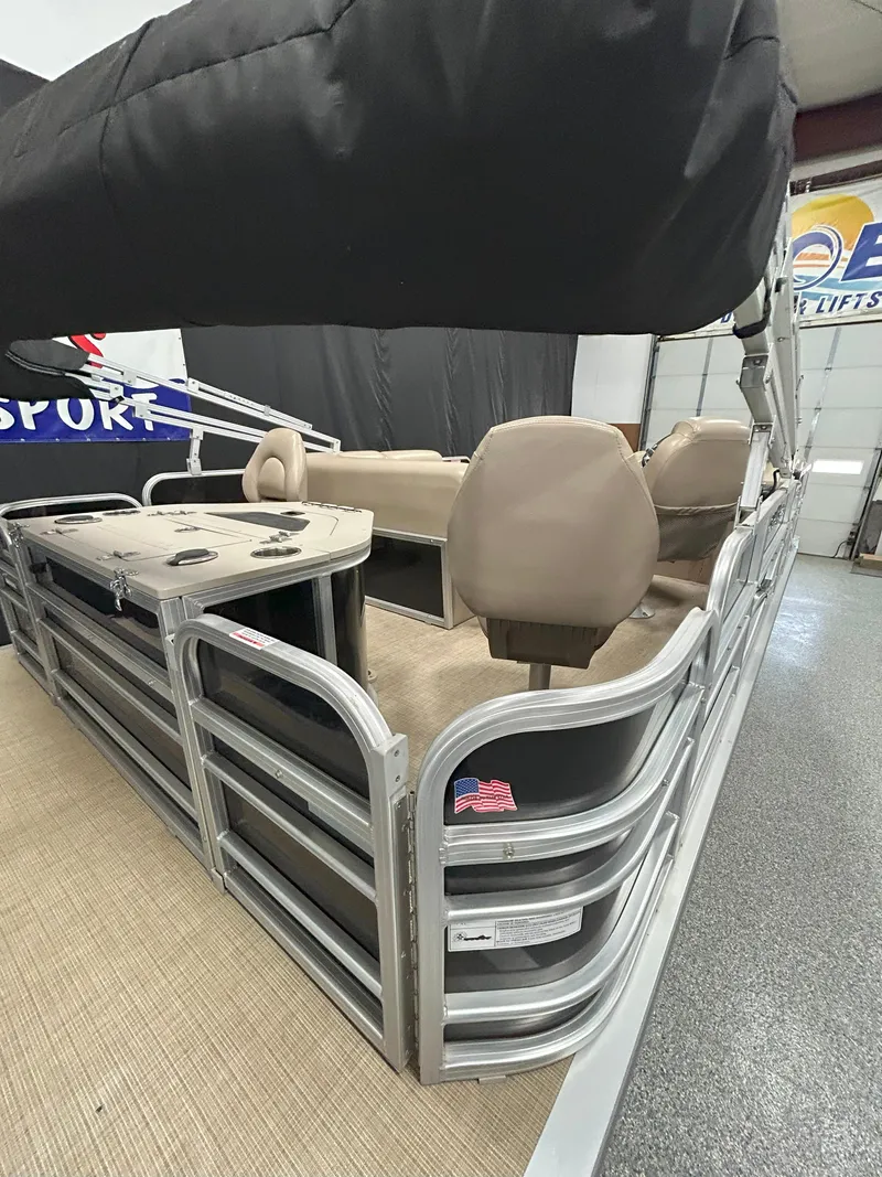 Slide: The Image of 2018 South Bay 220FCR pontoon boat interior with beige seating and American flag detail. - 4