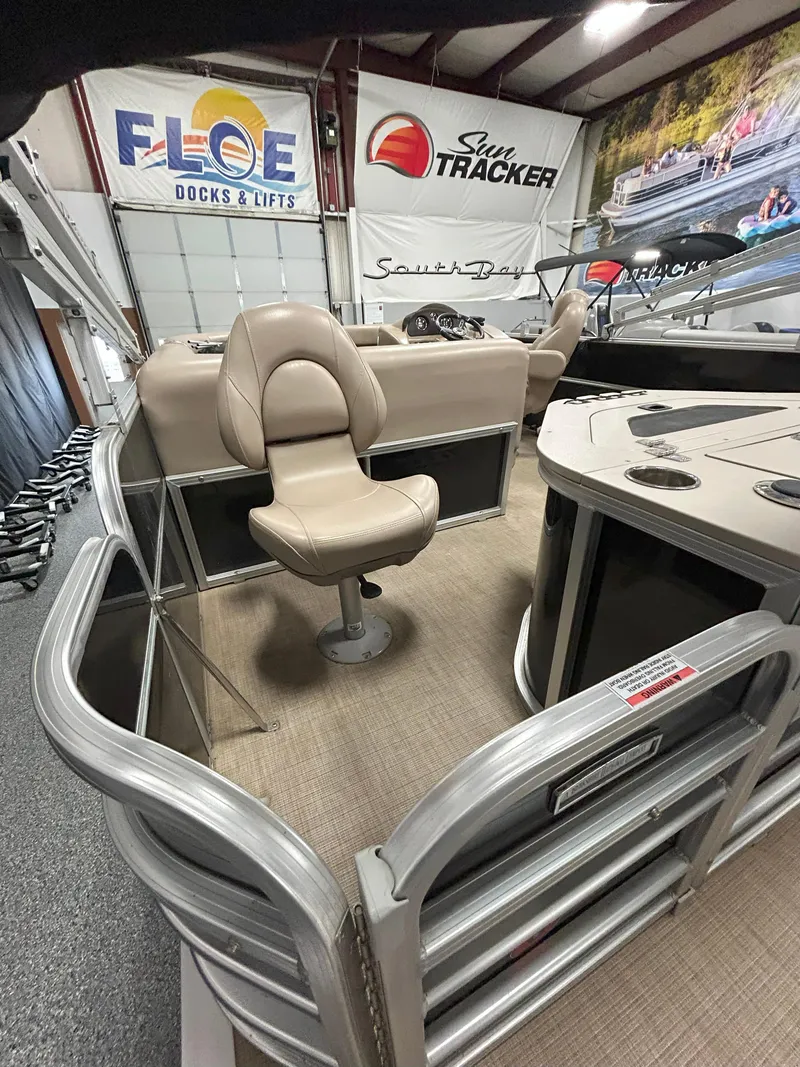 Slide: The Image of 2018 South Bay 220FCR pontoon boat interior with beige seating and control panel. - 5