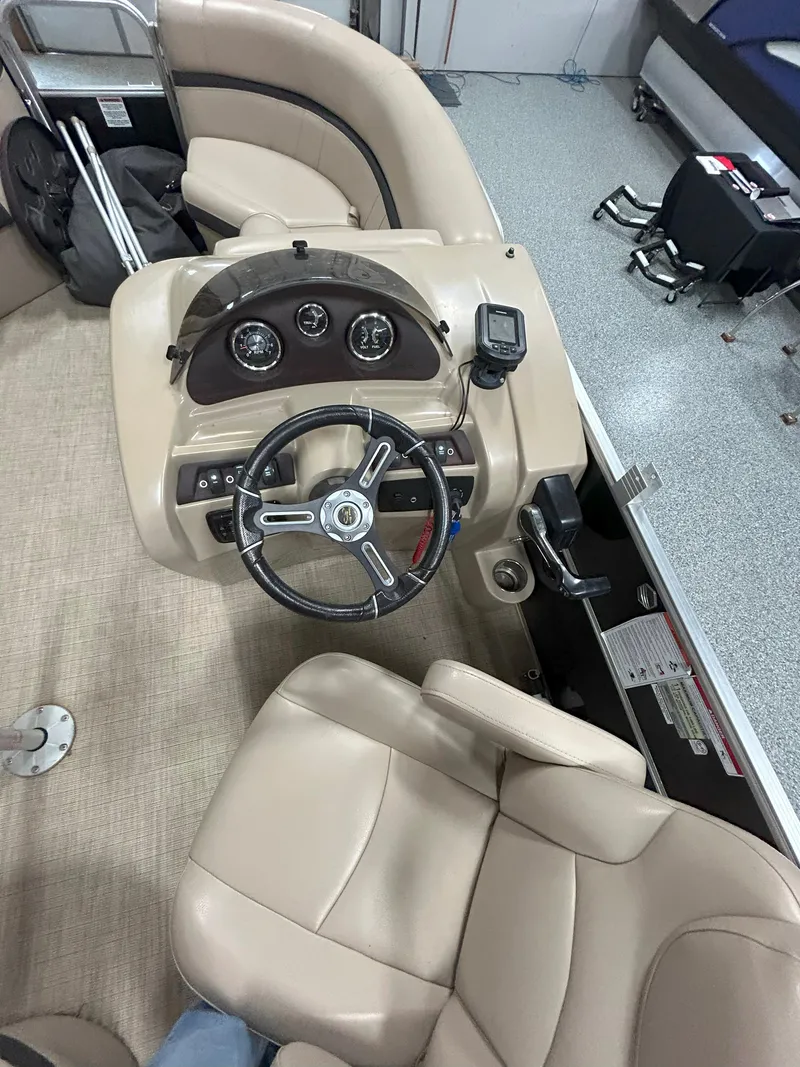 Slide: The Image of 2018 South Bay 220FCR boat interior with steering wheel and dashboard controls. - 7