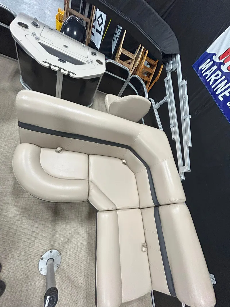 Slide: The Image of 2018 South Bay 220FCR pontoon boat interior with beige seating and helm. - 9