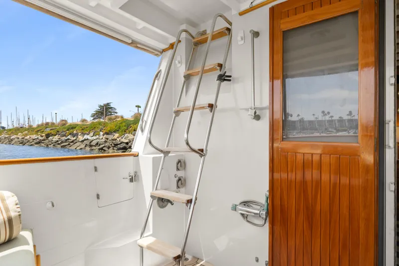 Slide: The Image of Kadey-Krogen 48 Whaleback yacht, 1996 model, featuring a wooden door and ladder on deck. - 10