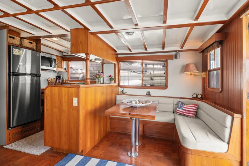 Slide: The Image of Interior of 1996 Kadey-Krogen 48 Whaleback yacht with cozy dining area and modern kitchen. - 13