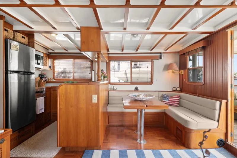 Slide: The Image of Interior of 1996 Kadey-Krogen 48 Whaleback yacht with cozy dining area and modern kitchen. - 14