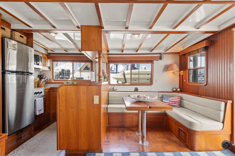 Slide: The Image of Interior of 1996 Kadey-Krogen 48 Whaleback yacht with wood finish and dining area. - 15
