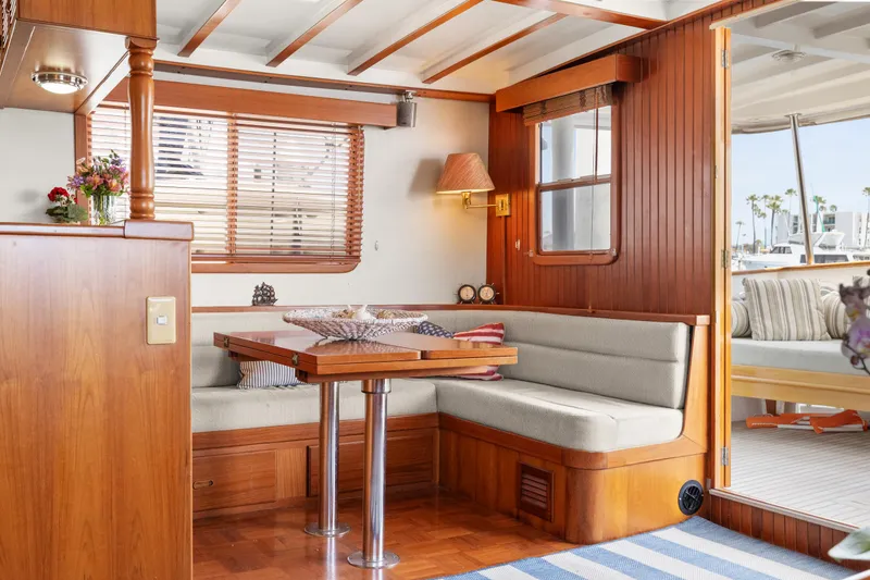 Slide: The Image of Interior of 1996 Kadey-Krogen 48 Whaleback yacht with cozy dining area and wooden accents. - 17