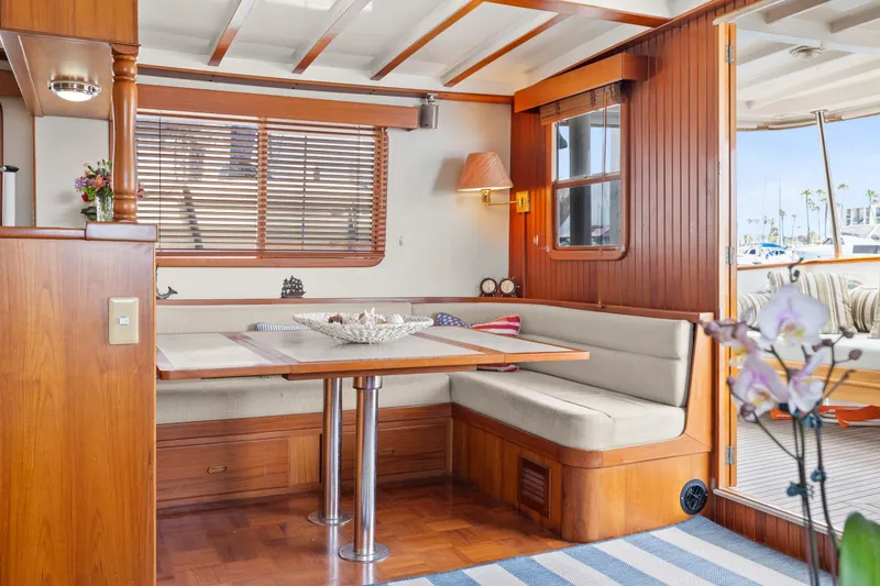 Slide: The Image of Interior of 1996 Kadey-Krogen 48 Whaleback yacht with cozy dining area and wooden accents. - 18