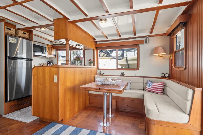 Slide: The Image of Interior of 1996 Kadey-Krogen 48 Whaleback yacht with cozy dining area and wooden finishes. - 20