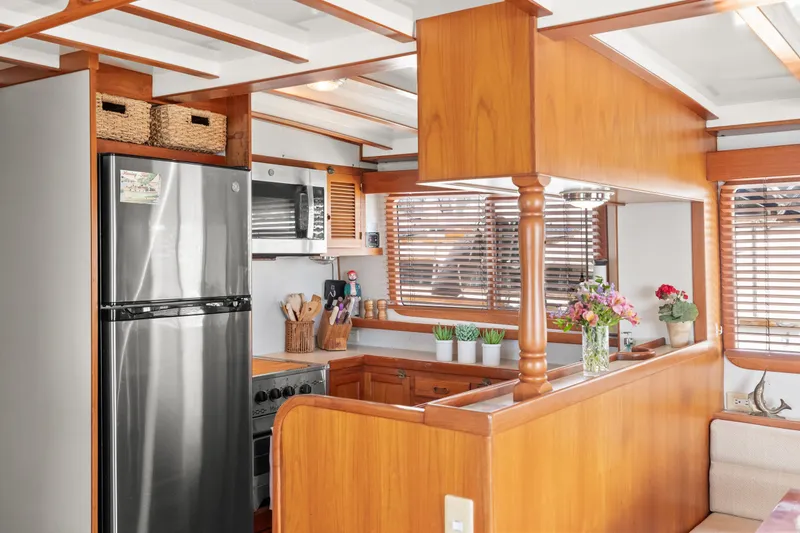 Slide: The Image of Kadey-Krogen 48 Whaleback 1996 yacht kitchen with wooden cabinetry and stainless steel appliances. - 27