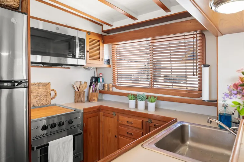 Slide: The Image of Cozy kitchen in 1996 Kadey-Krogen 48 Whaleback yacht with wooden cabinets and modern appliances. - 28