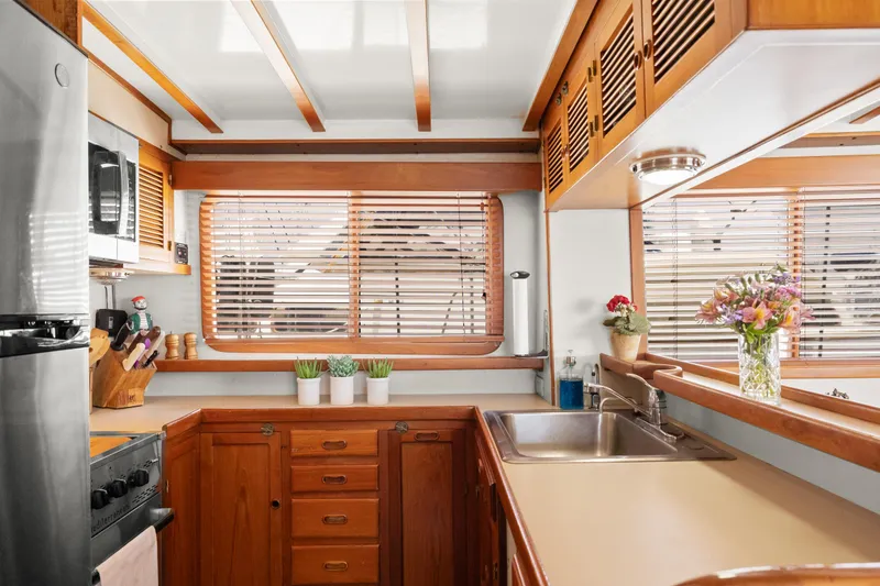 Slide: The Image of 1996 Kadey-Krogen 48 Whaleback yacht kitchen with wooden cabinets and modern appliances. - 29
