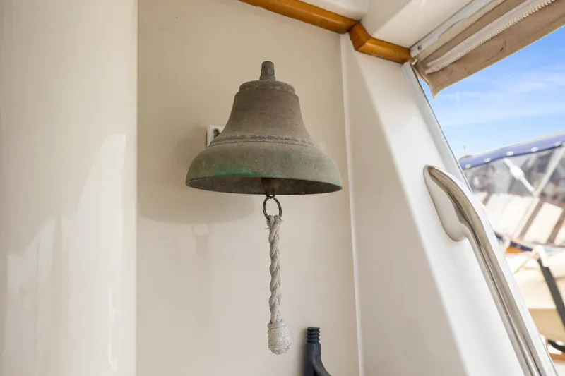 Slide: The Image of Bell on 1996 Kadey-Krogen 48 Whaleback yacht, with rope pull, nautical setting. - 3