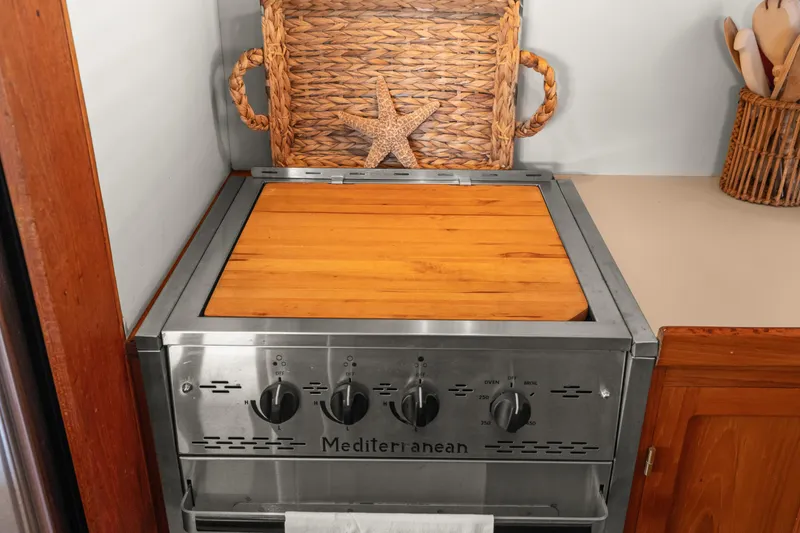 Slide: The Image of Stove with wooden cover in 1996 Kadey-Krogen 48 Whaleback yacht kitchen. - 31