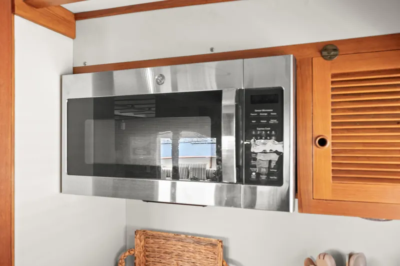 Slide: The Image of Microwave in 1996 Kadey-Krogen 48 Whaleback yacht kitchen, with wooden cabinetry. - 34