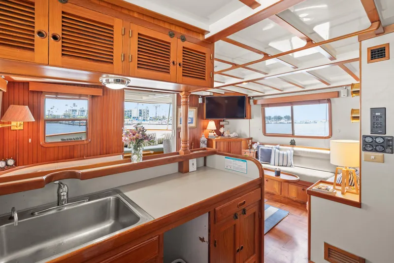 Slide: The Image of Interior of 1996 Kadey-Krogen 48 Whaleback yacht with wooden cabinetry and cozy seating area. - 35