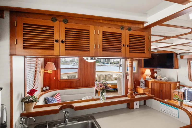 Slide: The Image of Interior of 1996 Kadey-Krogen 48 Whaleback yacht with wooden cabinetry and cozy seating area. - 36