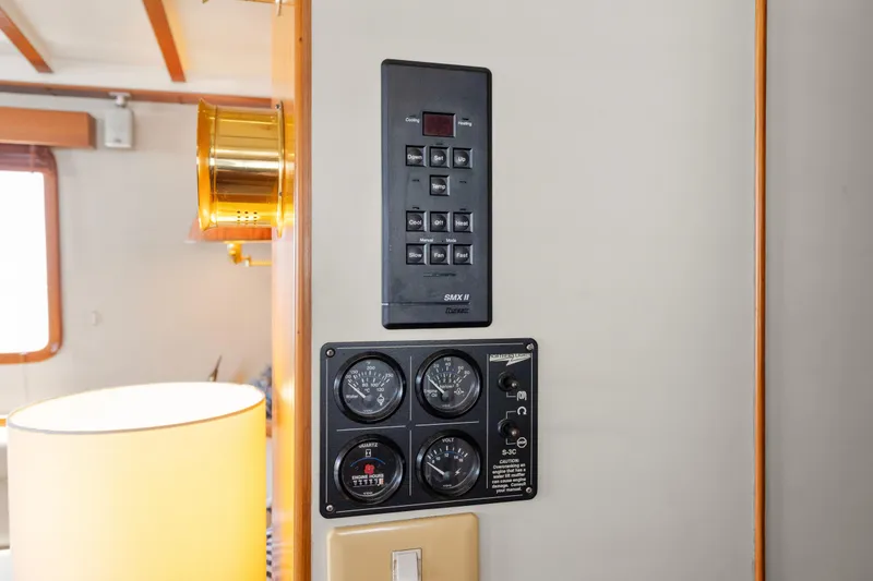 Slide: The Image of Control panel inside 1996 Kadey-Krogen 48 Whaleback yacht, featuring gauges and switches. - 37