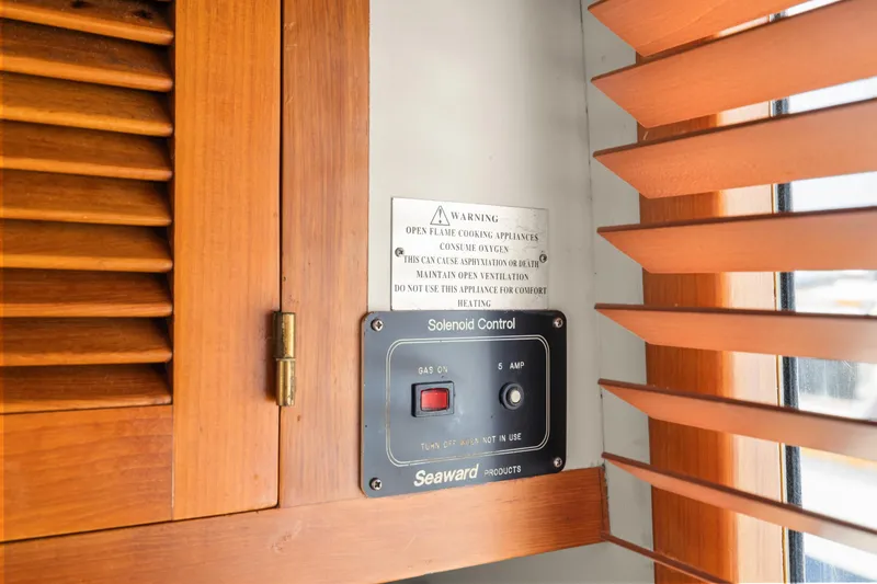 Slide: The Image of Solenoid control panel on 1996 Kadey-Krogen 48 Whaleback yacht, near wooden blinds and cabinet. - 39