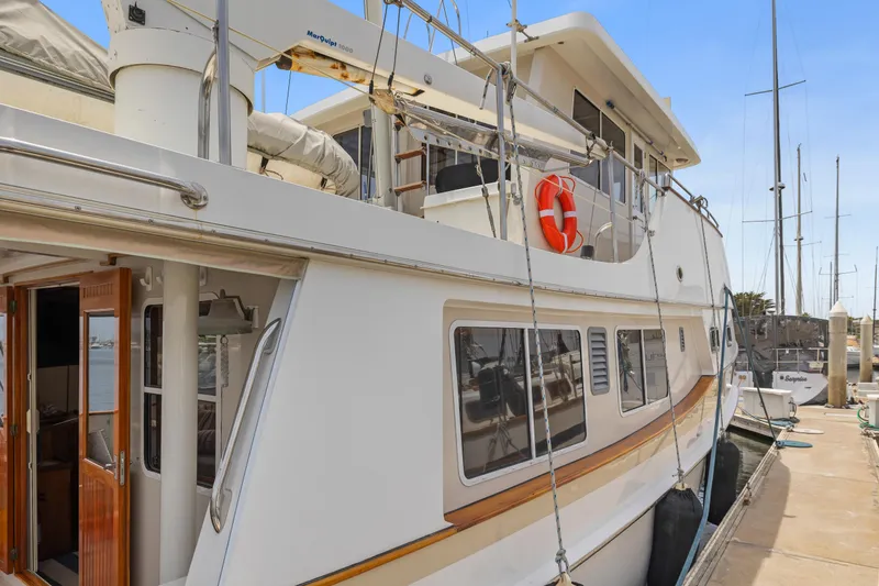 Slide: The Image of Kadey-Krogen 48 Whaleback yacht, 1996 model, docked at a marina. - 4