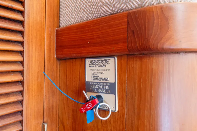 Slide: The Image of Fire extinguisher pull handle on 1996 Kadey-Krogen 48 Whaleback yacht interior. - 40