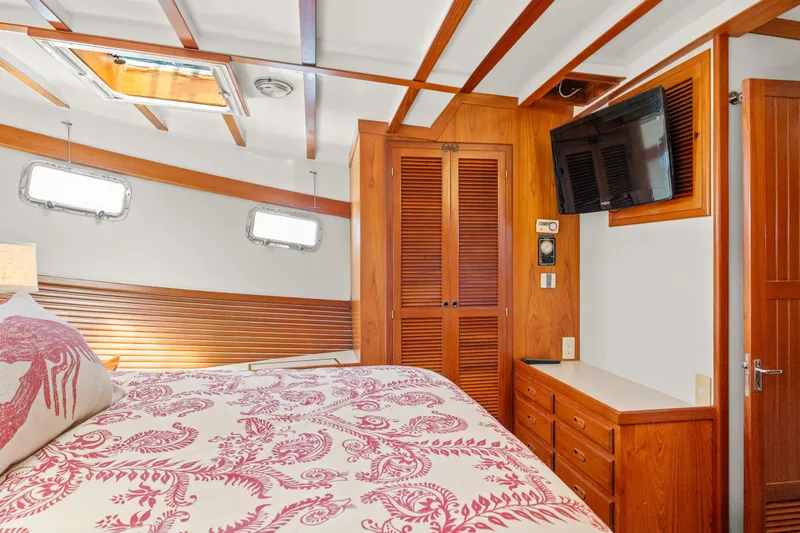 Slide: The Image of Cozy bedroom in 1996 Kadey-Krogen 48 Whaleback yacht with wood accents and floral bedding. - 44